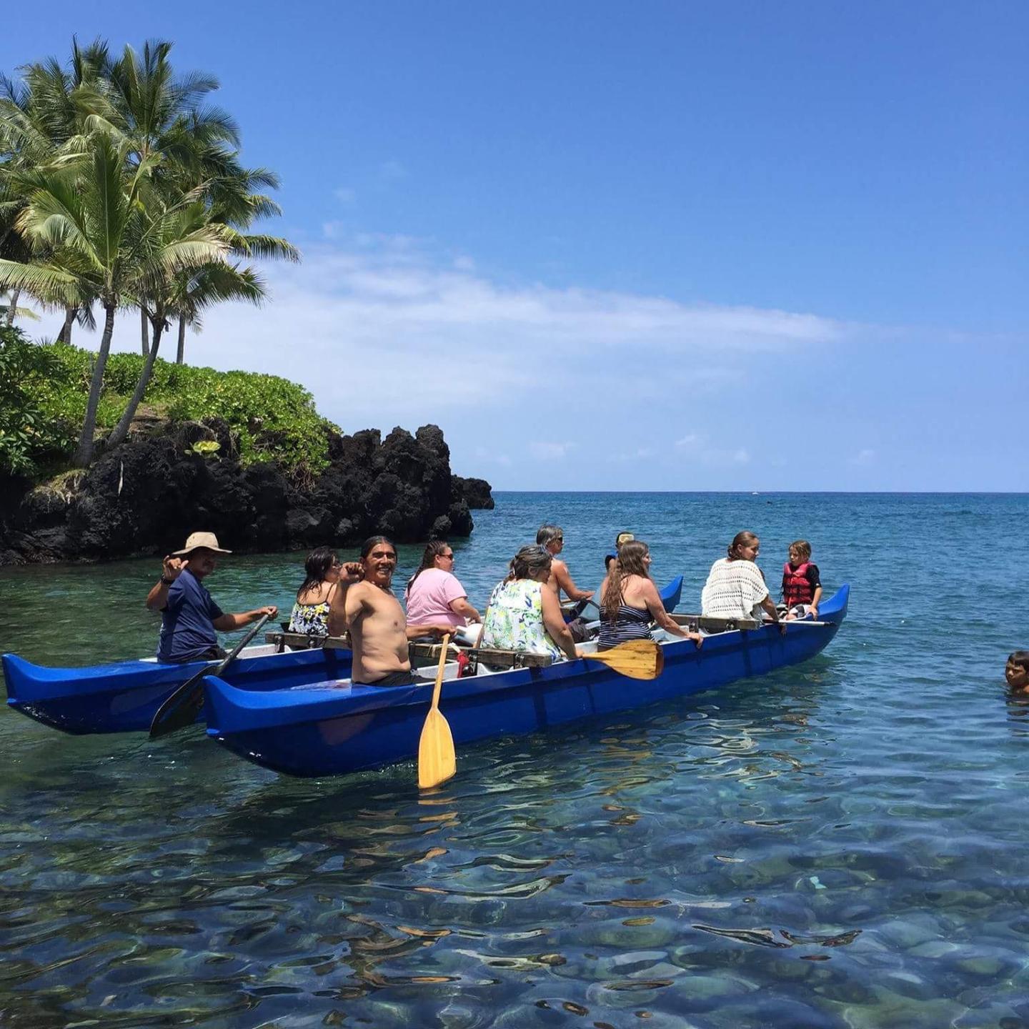 a group of people in a small boat in a body of water
