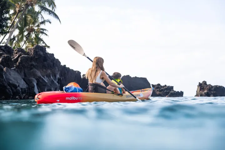 a group of people riding on the back of a boat