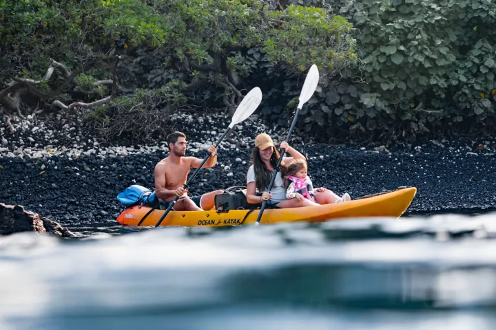 a group of people riding on the back of a boat